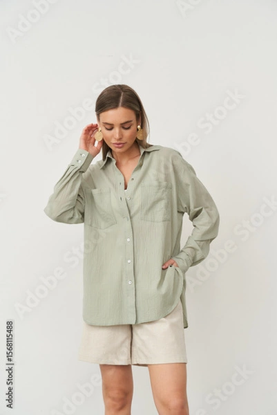 Fototapeta Stylish woman posing indoors in fashionable attire during a studio photoshoot