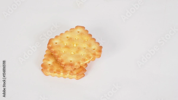 Fototapeta Cheese crackers with a golden brown color on white background
