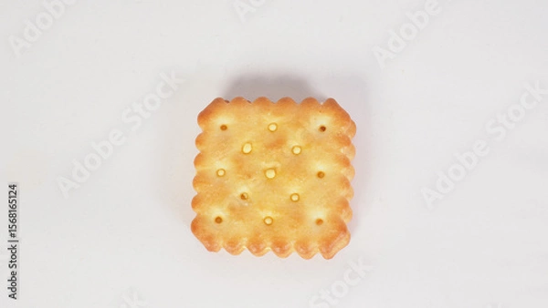 Fototapeta Cheese cracker with a golden brown color on white background