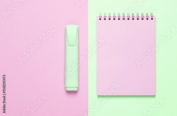 Fototapeta Notebook with a marker on a green-pink background. Top view