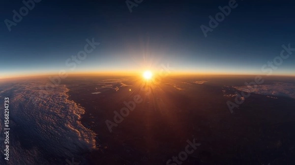 Obraz Panoramic view of Earth's sunrise, showing clouds and atmosphere.  A sunburst fills the horizon