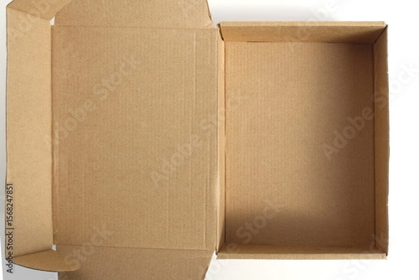 Fototapeta A brown cardboard empty box stands on a white background.