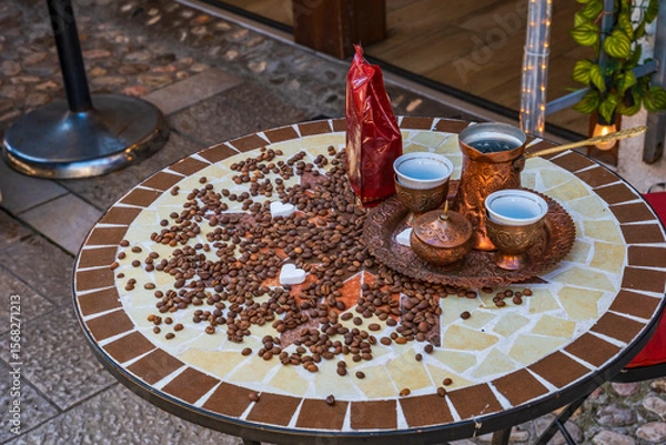 Fototapeta A Bosnian coffee set (kahveni takum) with copper cezve and cups on a table in old town of Sarajevo