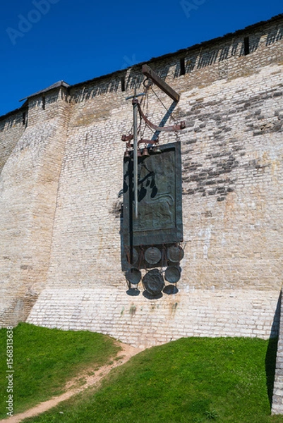 Fototapeta A view of the Pskov Kremlin fortress wall by Percy and Installation with a sword in honor of the victory over the Livonians in the Battle of the Icei, Pskov, Russia.