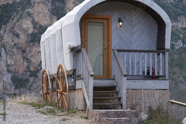 Fototapeta Conceptual design of a summer cafe in the form of a gypsy van against the backdrop of a steep cliff. Territory of the Chegem Aeroclub.