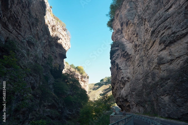 Fototapeta A clearing at the entrance (exit) to a narrow winding canyon with steep cliffs.
