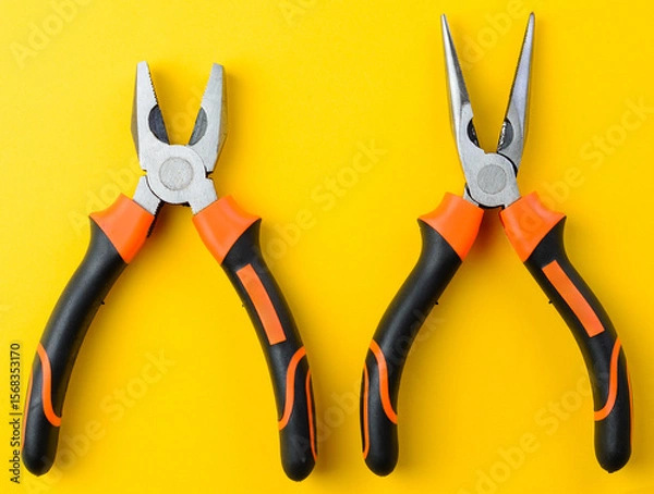 Fototapeta Two open metal pliers on bright yellow background, top view, repair tool