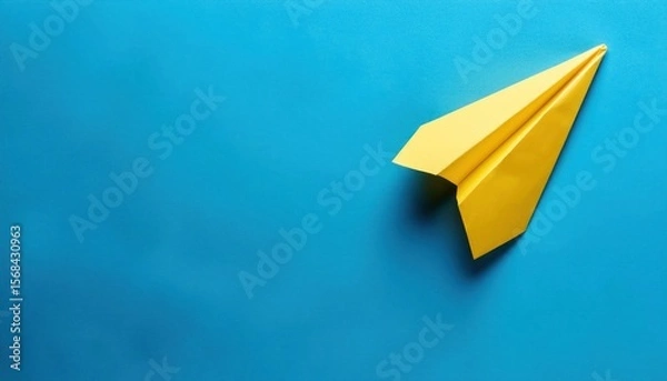 Obraz Yellow Paper Plane on Blue Background - Symbolizing Success in Business Growth