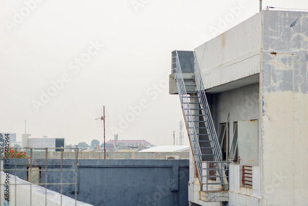 Obraz Multi-storey building roof with stairs