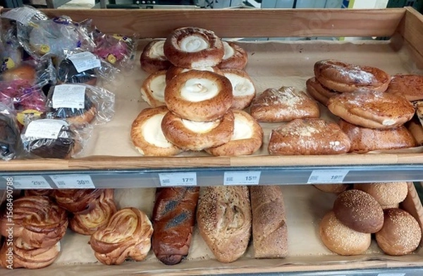 Obraz Freshly Baked Rolls and Pastries Available in Bakery Display at Local Shop