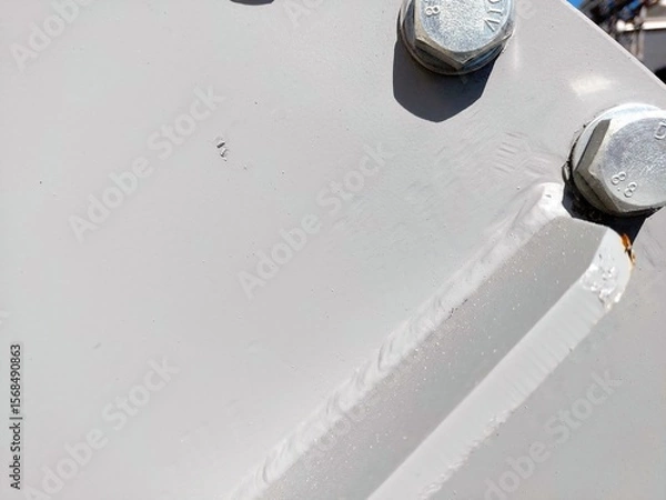 Obraz Close-up of Metallic Flange With Bolts and Nuts in Industrial Setting During Daylight Hours