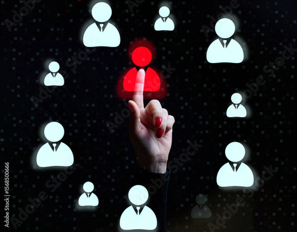 Fototapeta Female hand pointing at one red highlighted user icon among many blue icons on black background, recruitment concept