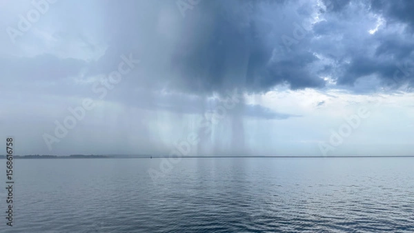 Fototapeta A sheet of rain coming down over the waters of the Chesapeake Bay