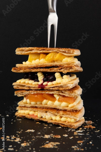 Fototapeta Delicious waffles with fruits on a black background, close-up