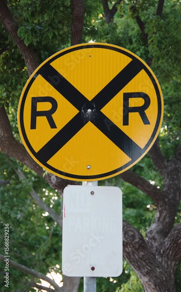 Obraz RAILROAD CROSSING road sign with faded  illegible no parking sign beneath