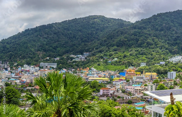 Fototapeta view of Patong and Patong Beach from the mountains colourful skies at Sunset. Patong is a vibrant city full of tourists from all around the world. 