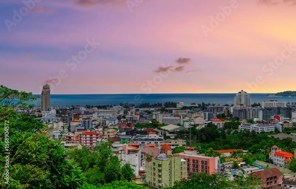 Fototapeta view of Patong and Patong Beach from the mountains colourful skies at Sunset. Patong is a vibrant city full of tourists from all around the world. 