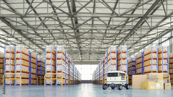 Obraz Autonomous delivery robot operates inside a modern warehouse filled with organized shelves of cardboard boxes- 3D rendering
