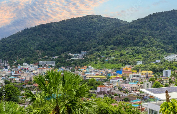 Fototapeta view of Patong and Patong Beach from the mountains colourful skies at Sunset. Patong is a vibrant city full of tourists from all around the world. 