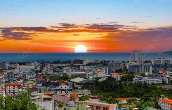 Fototapeta view of Patong and Patong Beach from the mountains colourful skies at Sunset. Patong is a vibrant city full of tourists from all around the world. 