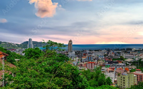 Fototapeta view of Patong and Patong Beach from the mountains colourful skies at Sunset. Patong is a vibrant city full of tourists from all around the world. 