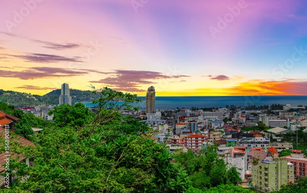 Fototapeta view of Patong and Patong Beach from the mountains colourful skies at Sunset. Patong is a vibrant city full of tourists from all around the world. 