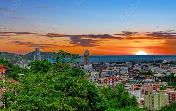 Fototapeta view of Patong and Patong Beach from the mountains colourful skies at Sunset. Patong is a vibrant city full of tourists from all around the world. 
