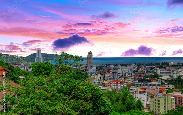 Fototapeta view of Patong and Patong Beach from the mountains colourful skies at Sunset. Patong is a vibrant city full of tourists from all around the world. 