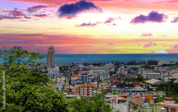 Fototapeta view of Patong and Patong Beach from the mountains colourful skies at Sunset. Patong is a vibrant city full of tourists from all around the world. 