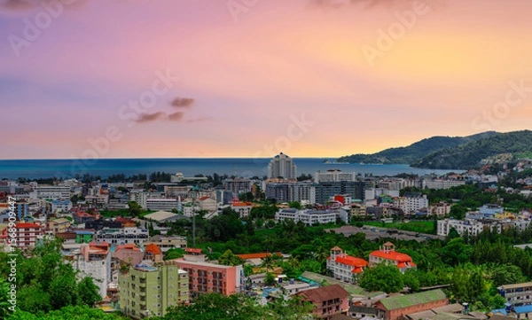 Fototapeta view of Patong and Patong Beach from the mountains colourful skies at Sunset. Patong is a vibrant city full of tourists from all around the world. 