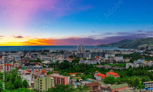 Fototapeta view of Patong and Patong Beach from the mountains colourful skies at Sunset. Patong is a vibrant city full of tourists from all around the world. 