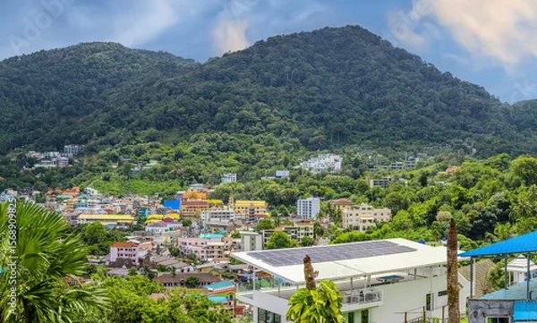 Fototapeta view of Patong and Patong Beach from the mountains colourful skies at Sunset. Patong is a vibrant city full of tourists from all around the world. 