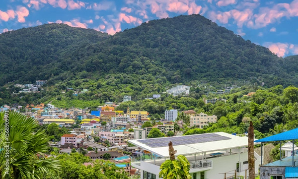 Fototapeta view of Patong and Patong Beach from the mountains colourful skies at Sunset. Patong is a vibrant city full of tourists from all around the world. 
