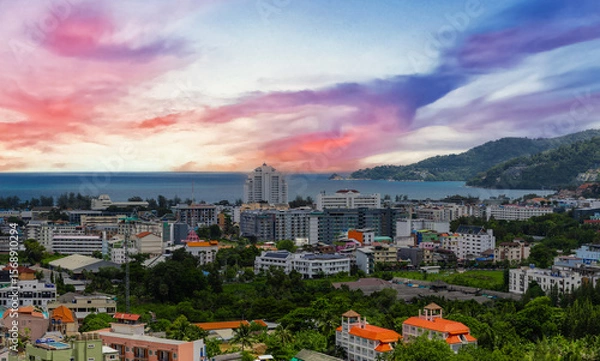 Fototapeta view of Patong and Patong Beach from the mountains colourful skies at Sunset. Patong is a vibrant city full of tourists from all around the world. 