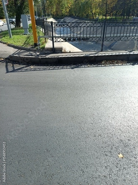 Obraz Roadway scene with asphalt and fence