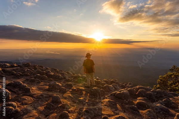 Fototapeta A man with a landscape of the rocky courtyard in the cliffs in the national park in Thailand at the sunset,Lan Hin Pum ,Phitsanulok