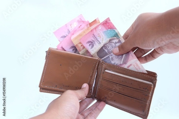 Fototapeta Keep money in wallet. Save money.