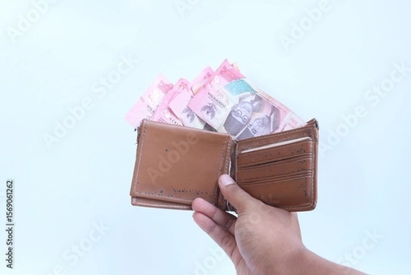 Fototapeta Keep money in wallet. Save money.