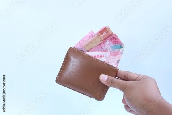 Fototapeta Keep money in wallet. Save money.