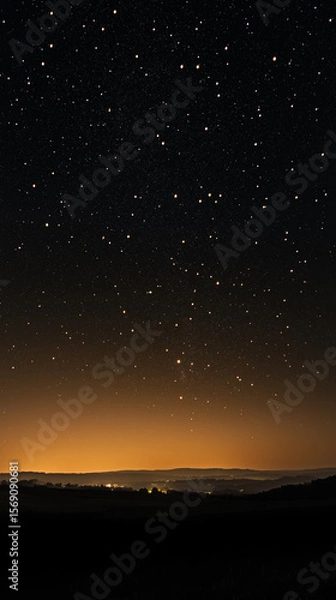 Obraz A serene view of a starlit night sky over a dark landscape, a beautiful combination of nature's celestial wonders.