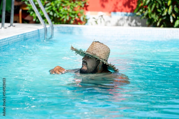 Fototapeta Tourist enjoying his vacation , relaxing by the pool in Tortuguero, Costa Rica