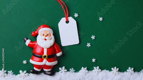 Obraz Festive Christmas tag design featuring cheerful Santa Claus and gentle snow falling on a vibrant green background. Includes blank copy space for personalized holiday messages or branding.