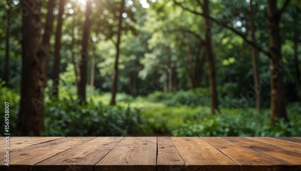 Fototapeta Empty Wooden Tabletop with Blurred Forest Background for Product Display.