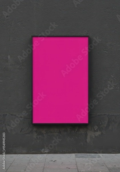 Fototapeta Photo of a vibrant magenta poster is displayed against a textured gray wall