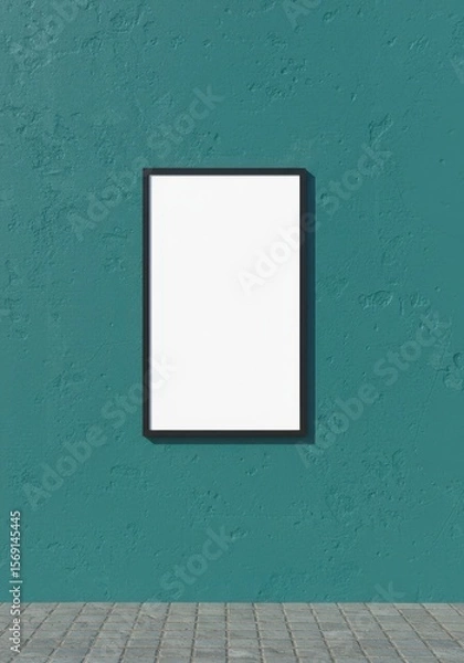 Fototapeta Photo of a blank frame is displayed on a textured teal wall