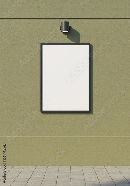 Fototapeta Photo of a blank poster frame hangs on a textured green wall with a lamp above it