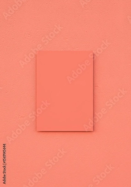 Fototapeta Photo of a blank square poster frame is mounted on a textured orange wall