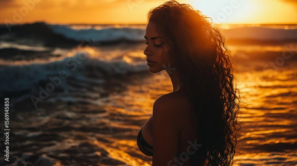 Fototapeta Golden hour at the beach with a young woman with long curly hair standing in the water. Perfect for lifestyle and vacation themes. Generative AI.

