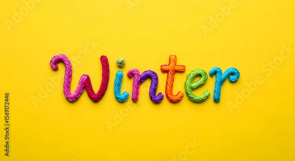 Obraz Winter Written in Colorful Embroidery Thread on a Yellow Background The word "Winter" is spelled out using vibrant, textured embroidery