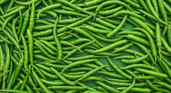 Obraz A Verdant Abundance: A Captivating Cluster of Fresh, Vibrant Green Chili Peppers A dense array of bright green chili peppers